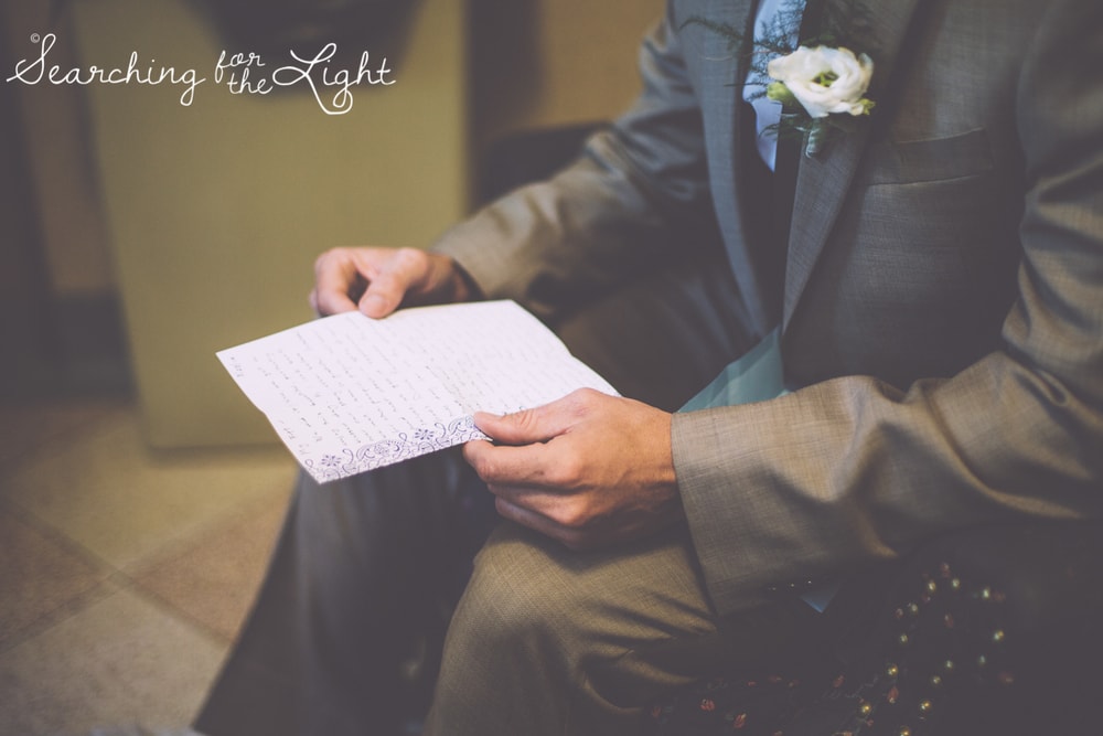 groom reading note from bride at Holy Ghost Catholic church, colorado wedding photographer photos
