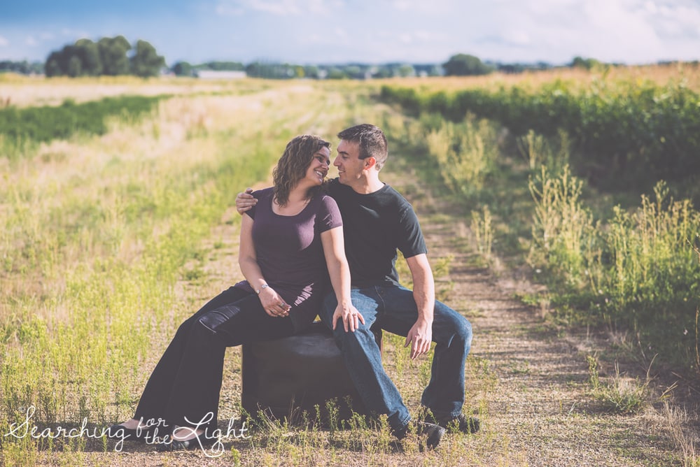 colorado wedding photographer field engagement session featuring suitcases