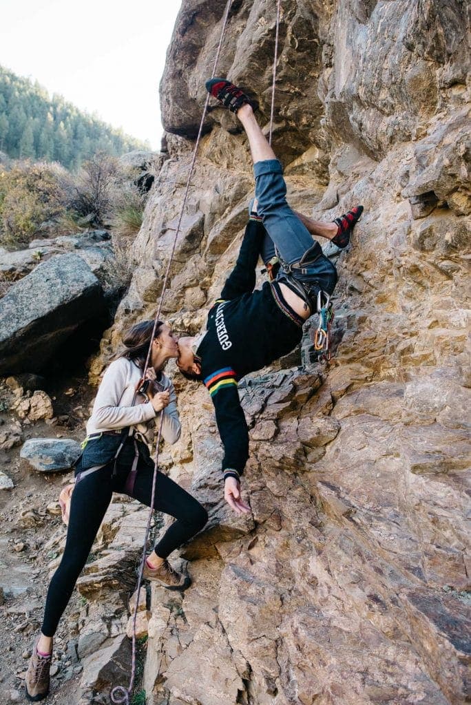 couple rock climbing on their best anniversary trip in Golden, Colorado