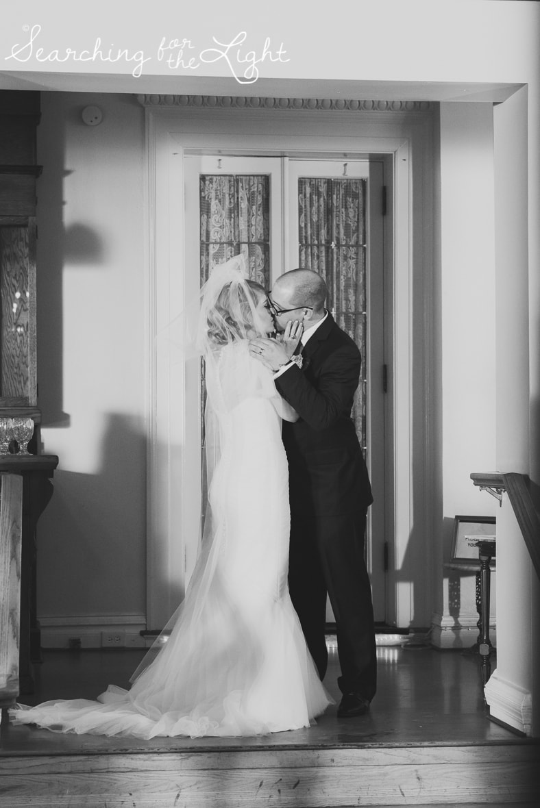 first kiss indoor ceremony at Parkside mansion wedding photo by denver wedding photographer, romantic evening wedding photo, city wedding