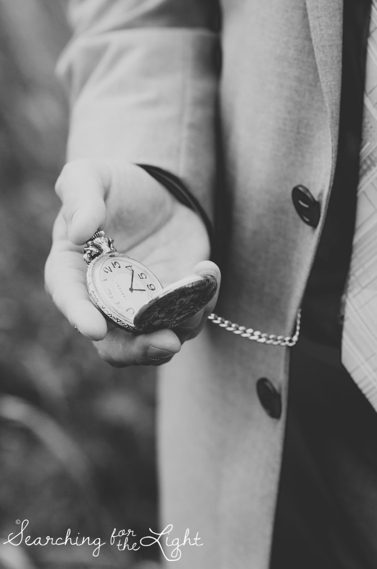 Groom carrying grandfather's pocket watch Lakewood stone house wedding photos by Denver wedding photographer searchingforthelight.com