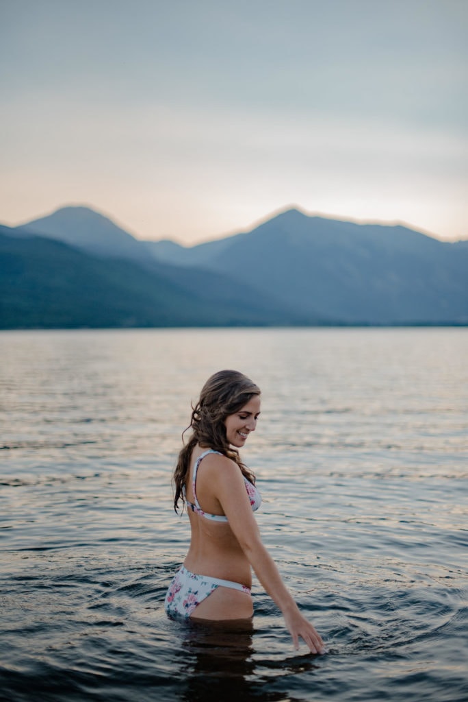 girl swimming| girl in water swimming in an alpine lake