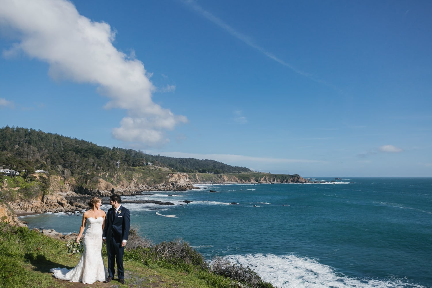couple on cliffside near pacific ocean