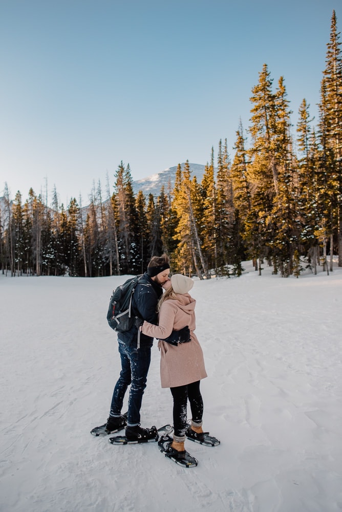 Couple snowshoeing in the mountains who had fun using this fun date ideas list