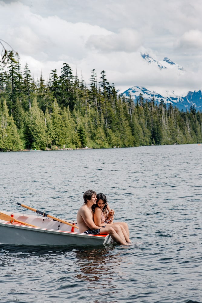 couple in a canoe at mount hood area near lost lake resort smiling at their oregon elopement photographer