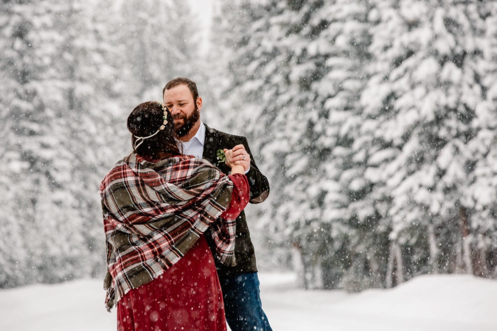 couple dancing in the snow in winter