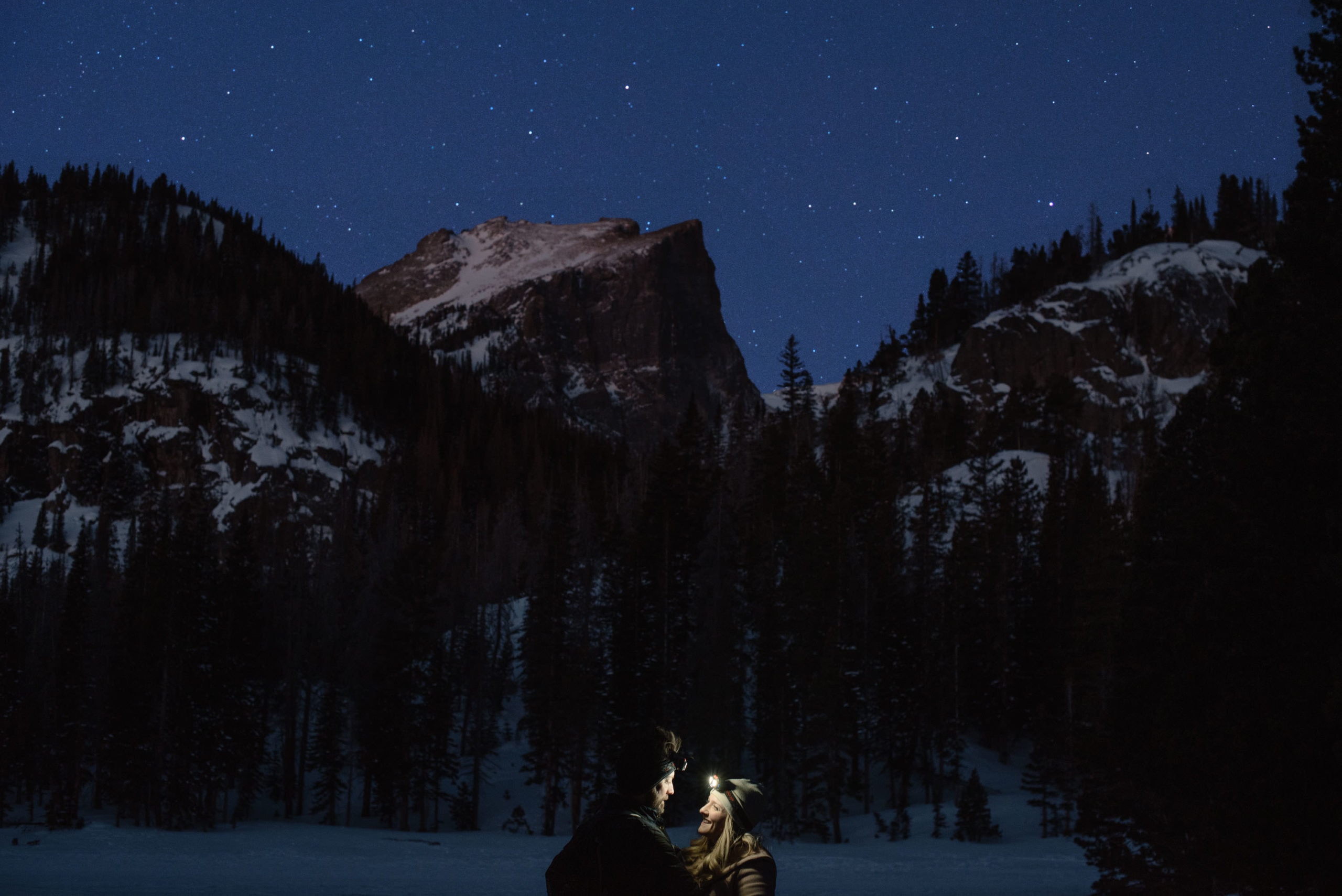 couples in the mountains with headlamps on