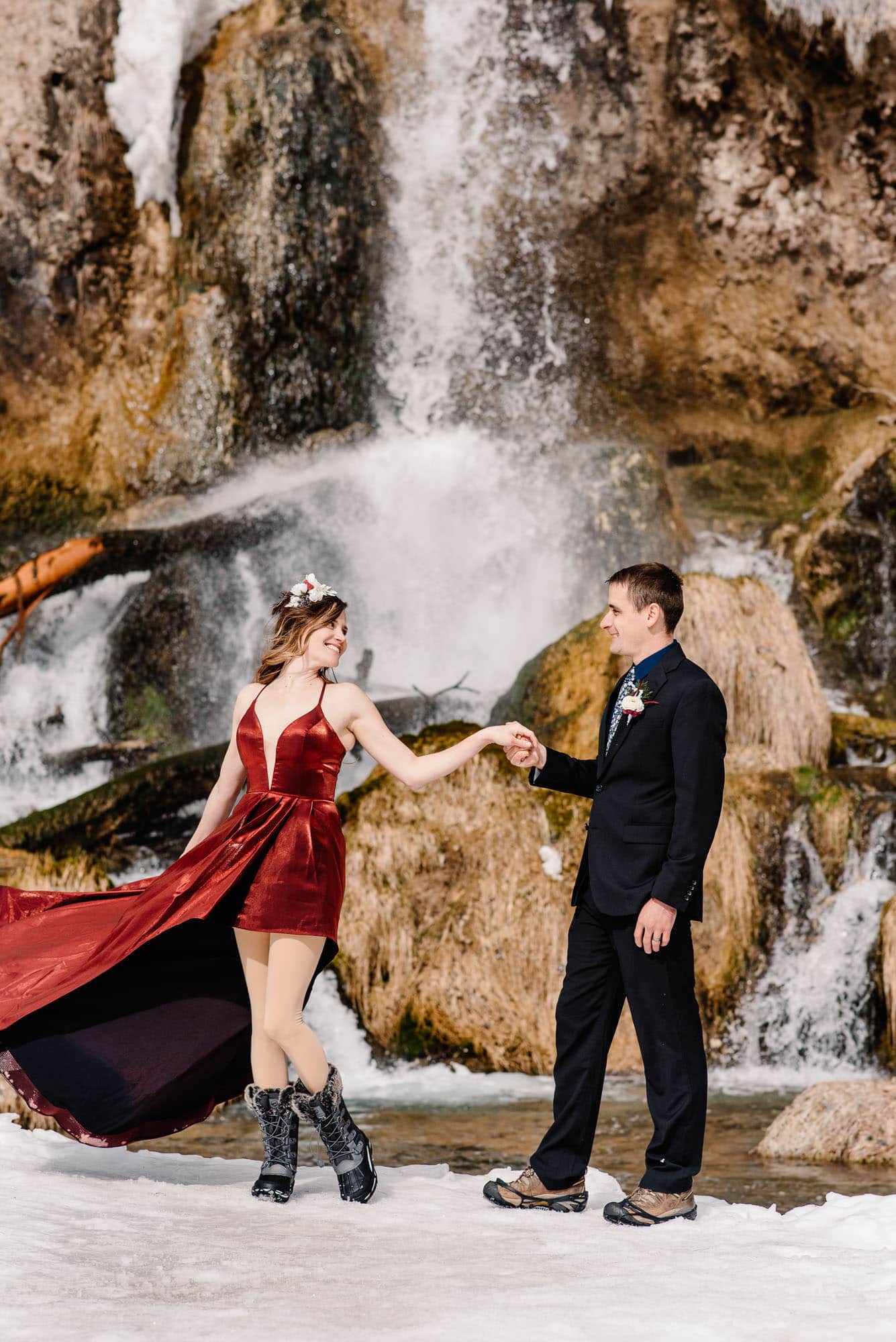 couple dancing near a waterfall