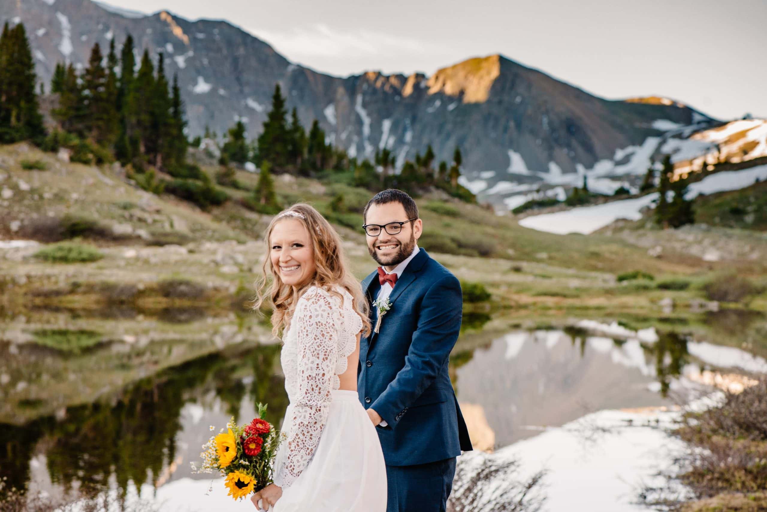 couple standing in mountains near Oregon as they smile at their Oregon Elopement Photographer