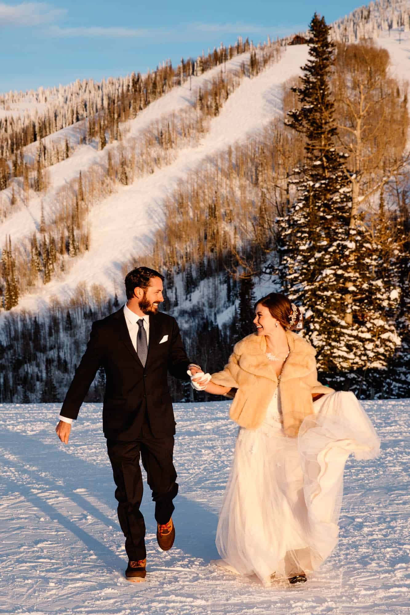 couple on the ski slopes of their wedding day