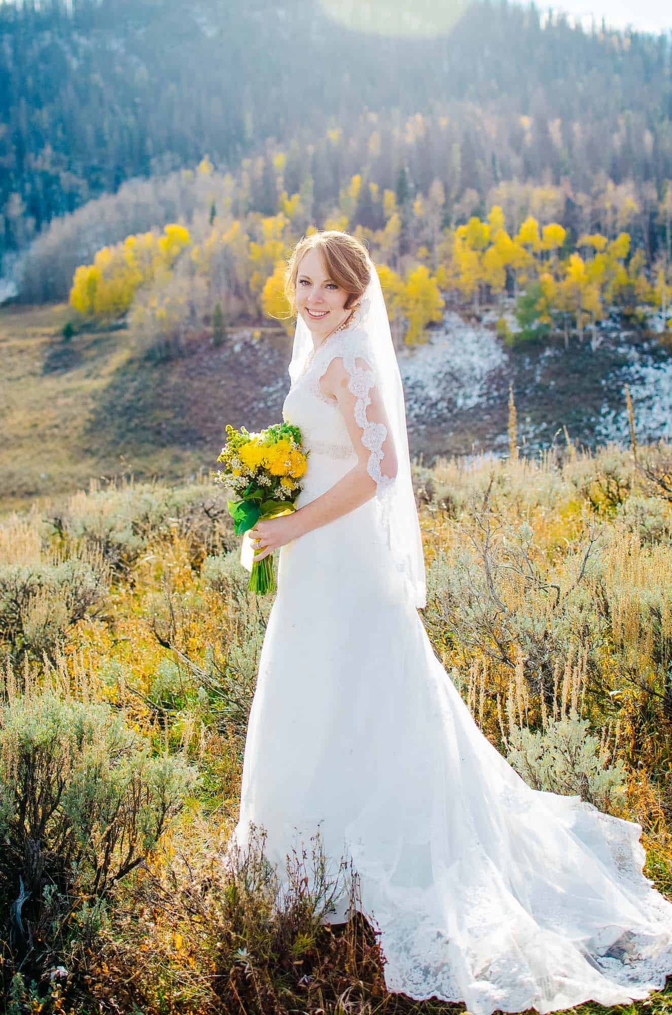 bride in aspens during the fall on her wedding day