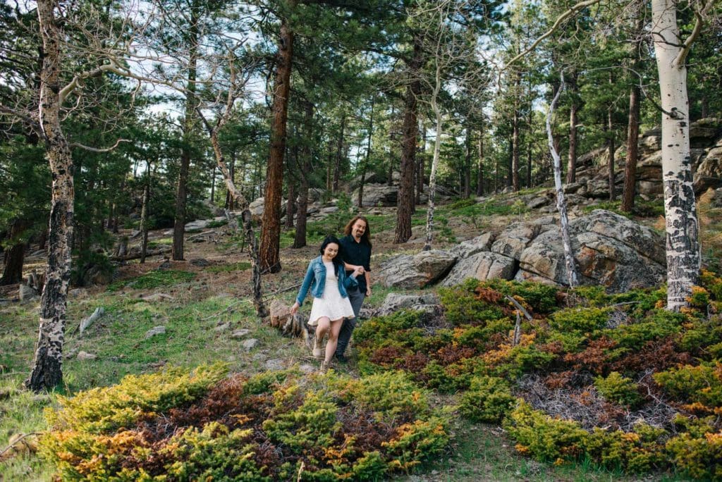 newly weds walking in a mossy field of trees