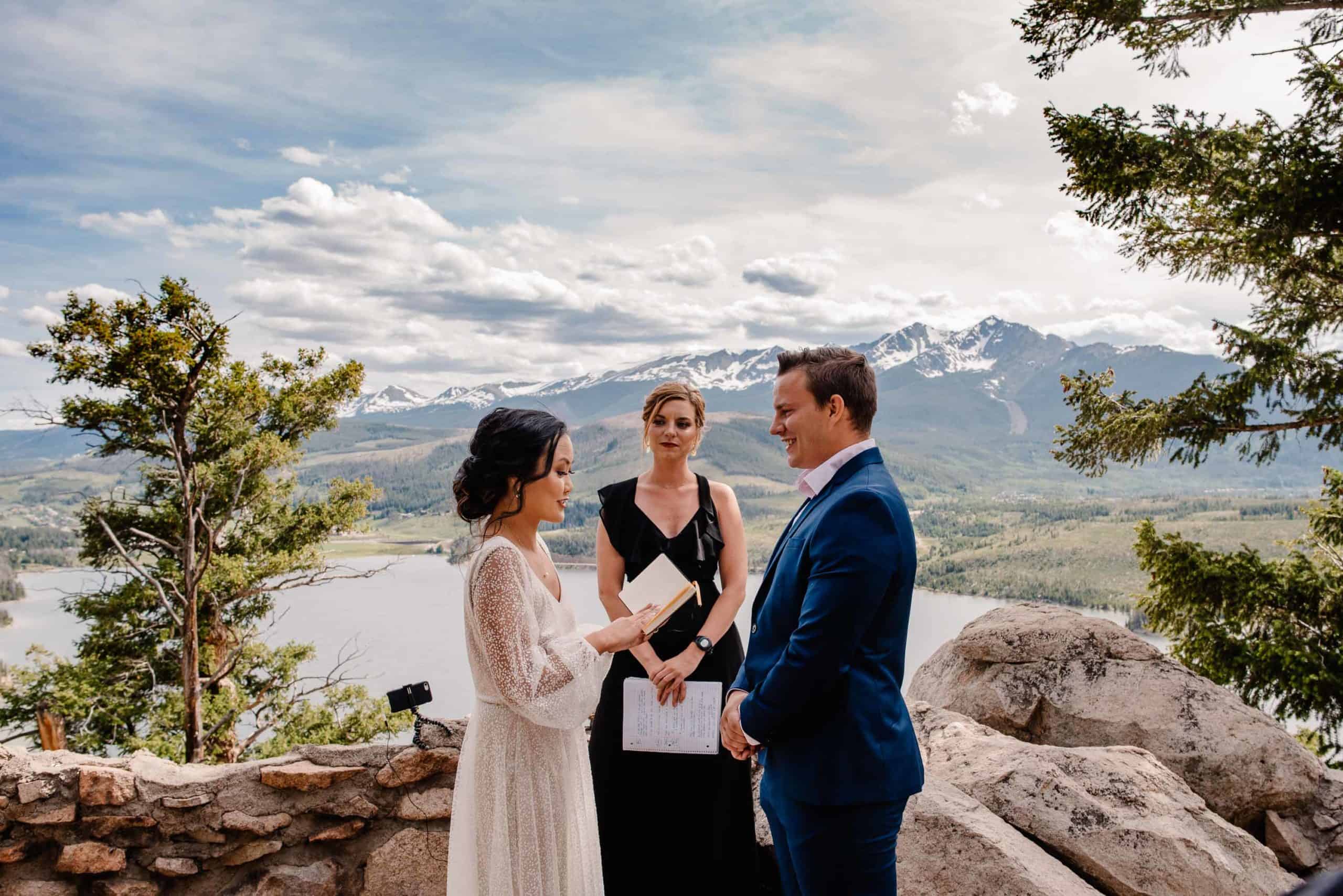 couple who followed this elopement timeline to craft their elopement ceremony structure couple exchanging vows on a mountain top