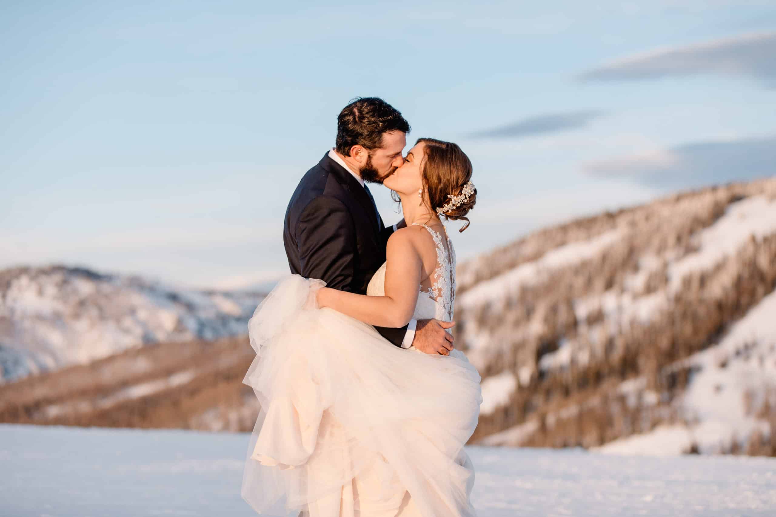 couple standing on a mountain top after their adventurous elopement