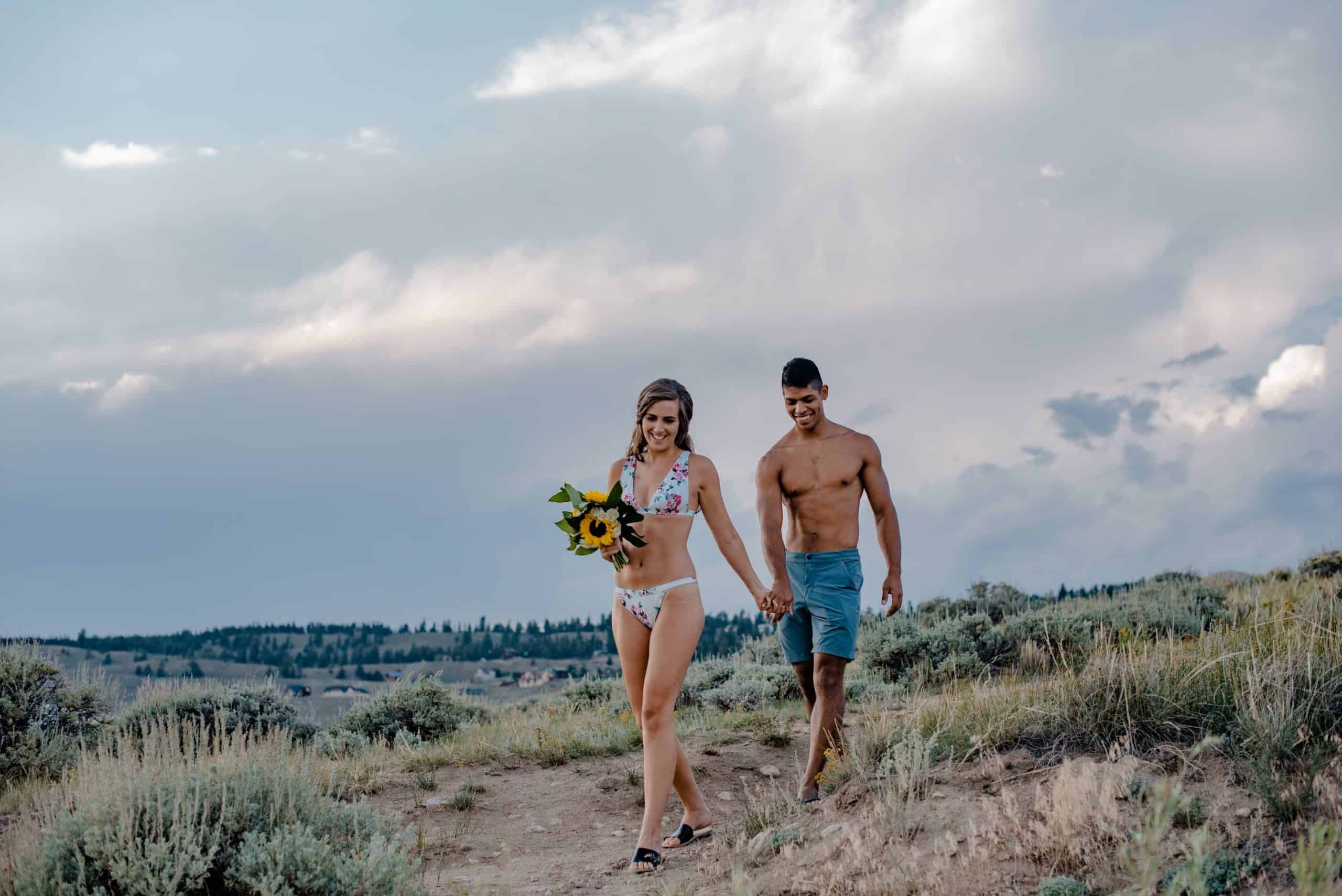 couple swimming in a mountain lake on their elopement wedding day