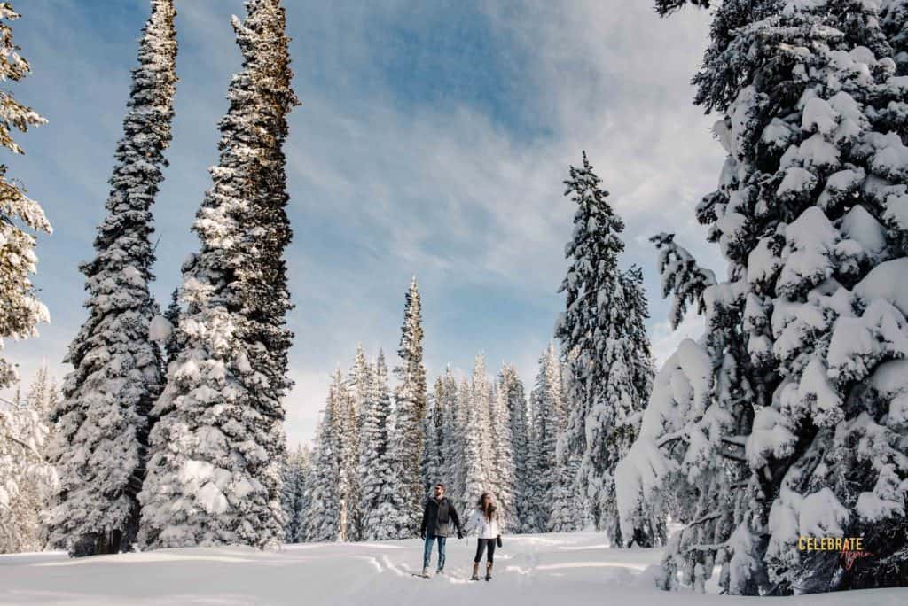 couple snowshoeing for their engagement photos