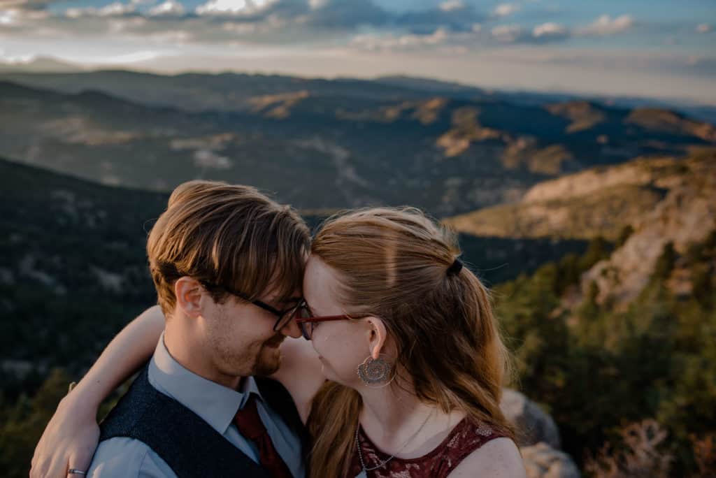 couple snuggling after elopement in mountain