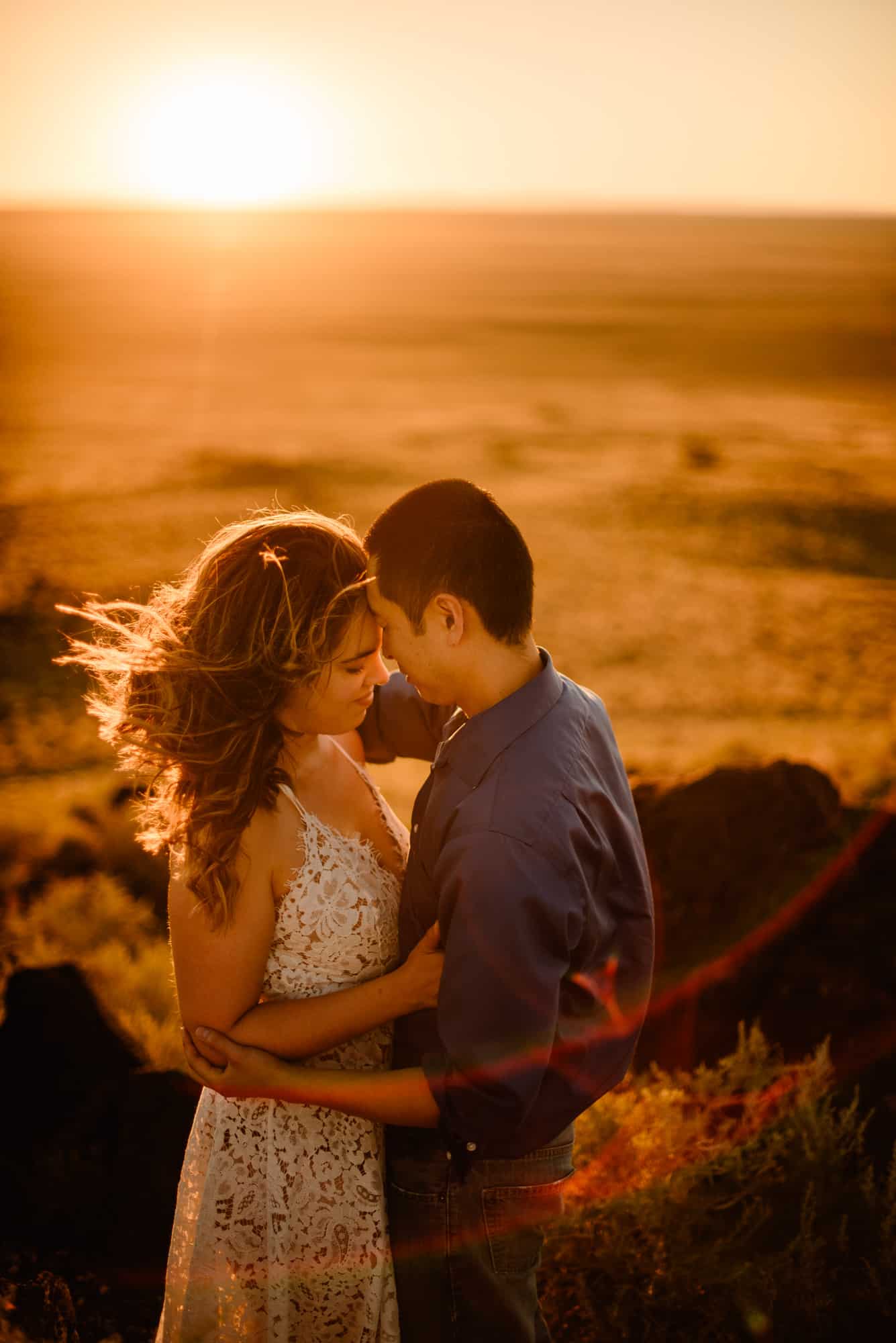 couple cuddling as the sunsets behind them who decided eloping isn't selfish for them as christians