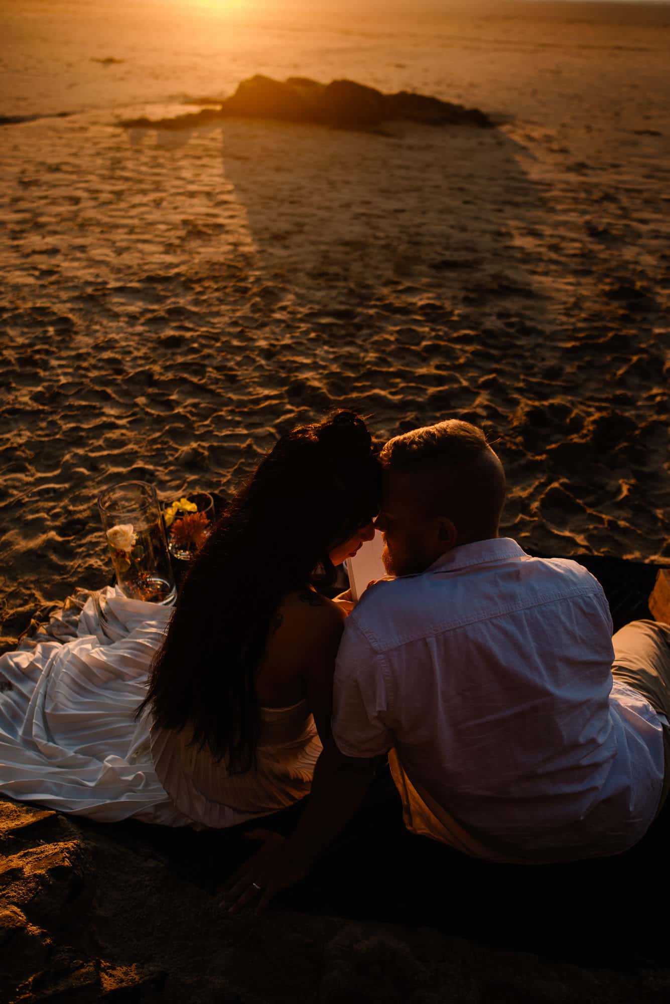 couple snugging at sunset as they contemplate "is eloping selfish as christians"