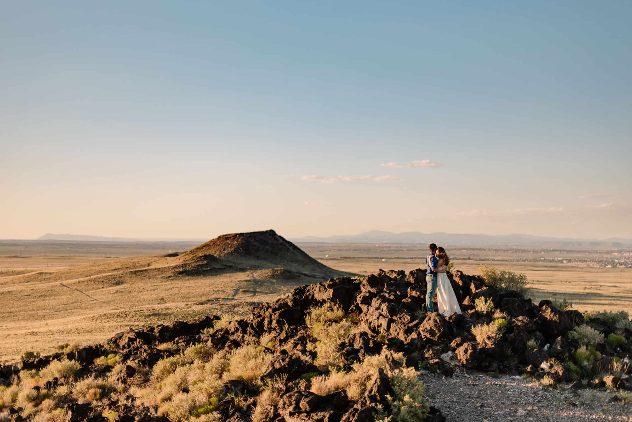 couple standing on a cliffs edge in an Albuquerque elopement and New Mexico desert elopement wedding