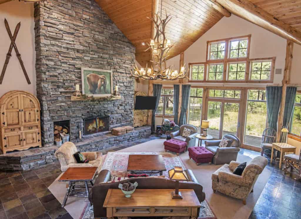 ranch style living room with a stone fire place