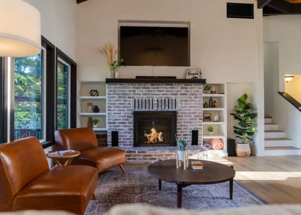 living room with a fire place and cozy modern chairs