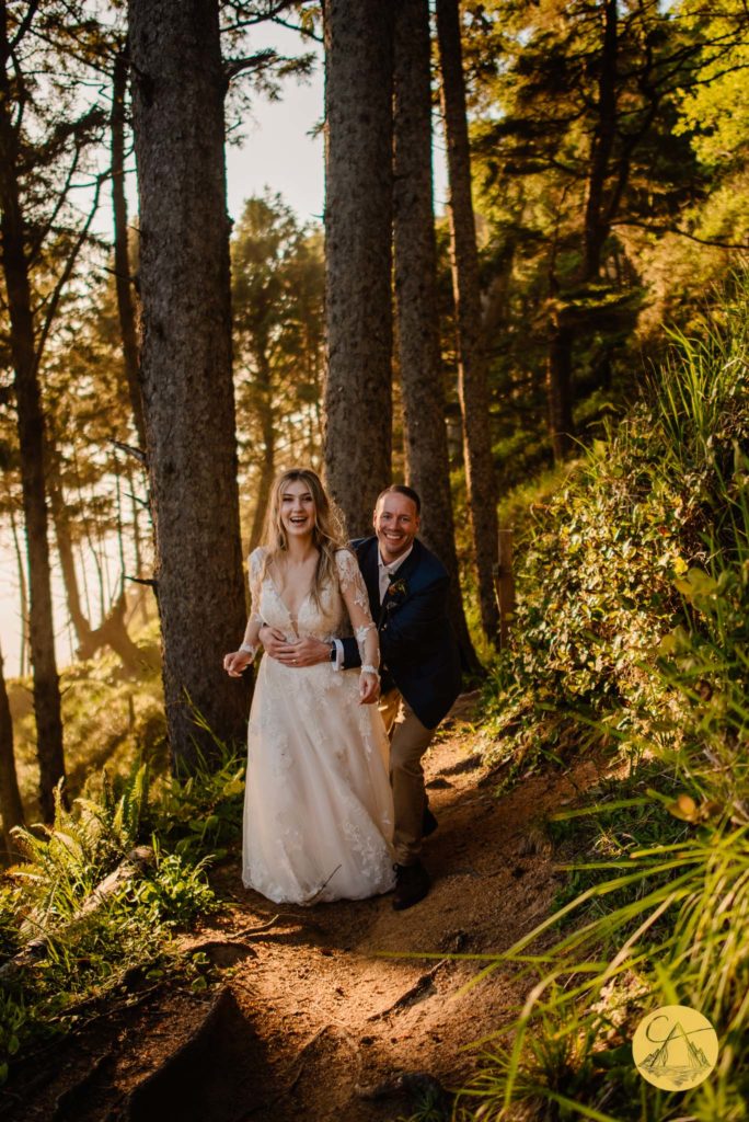 bride and groom laughing in the forest after their Ecola State Park Forest after their wedding ceremony
