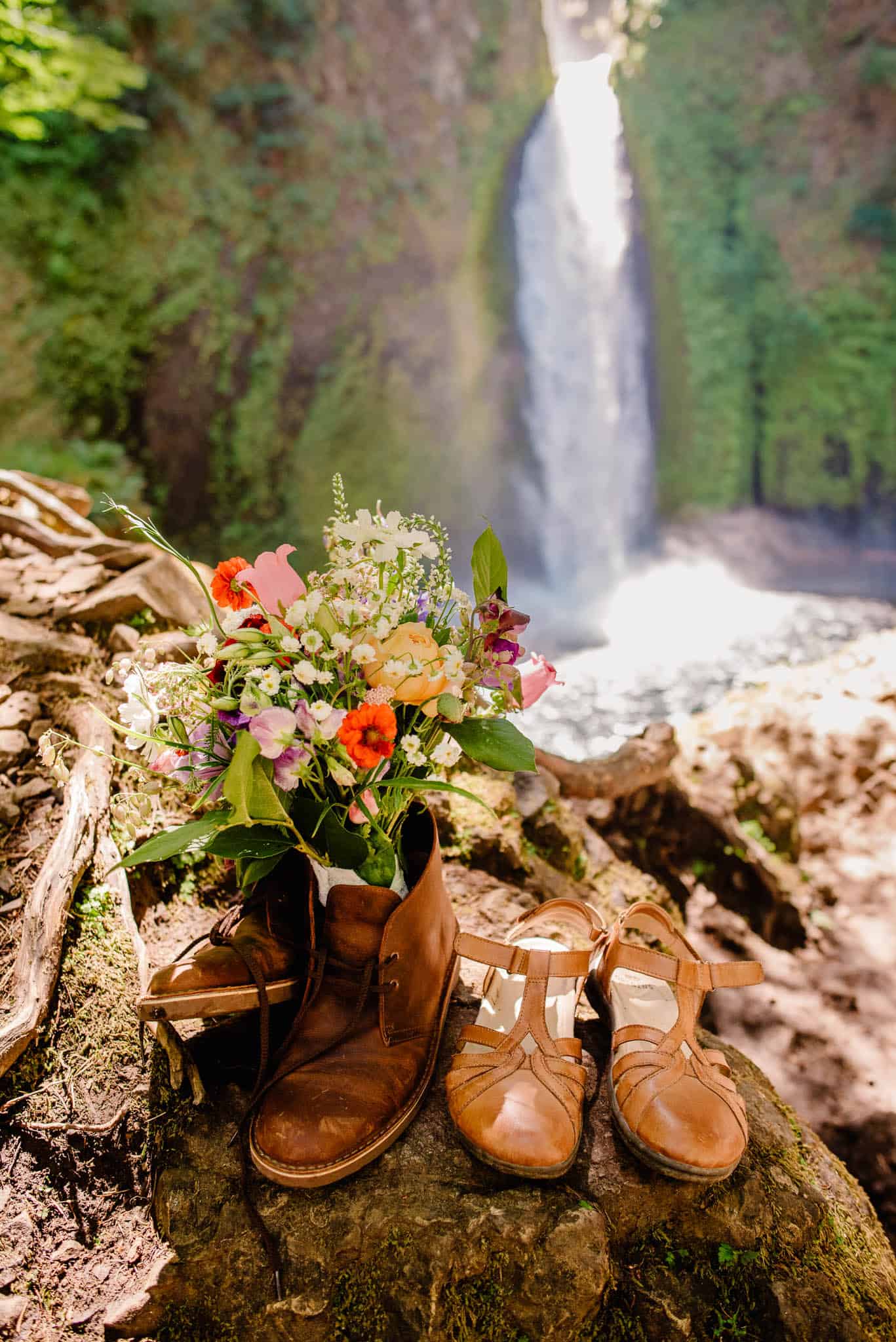 grooms shoes and brides flowers at this bride and groom exchanging rings at Wahclella Falls wedding