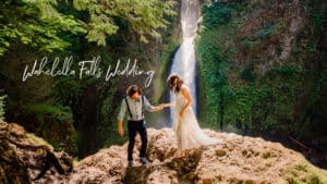 groom holding brides hand as she walks down a rock with wahclella falls behind them and text over that says "wahclella falls wedding"