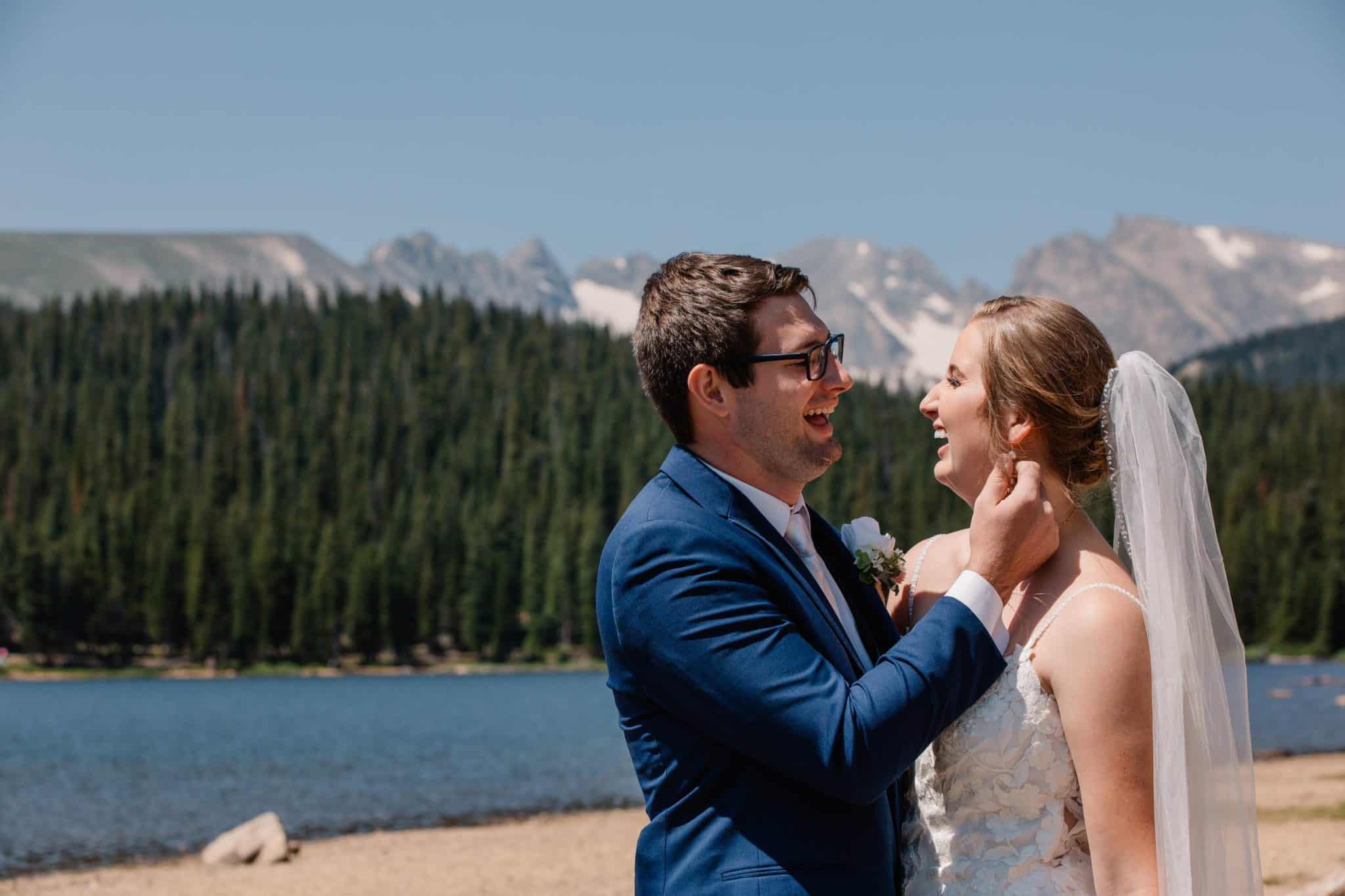 bride and groom touching Brianard Lake wedding in Indian Peaks Wilderness