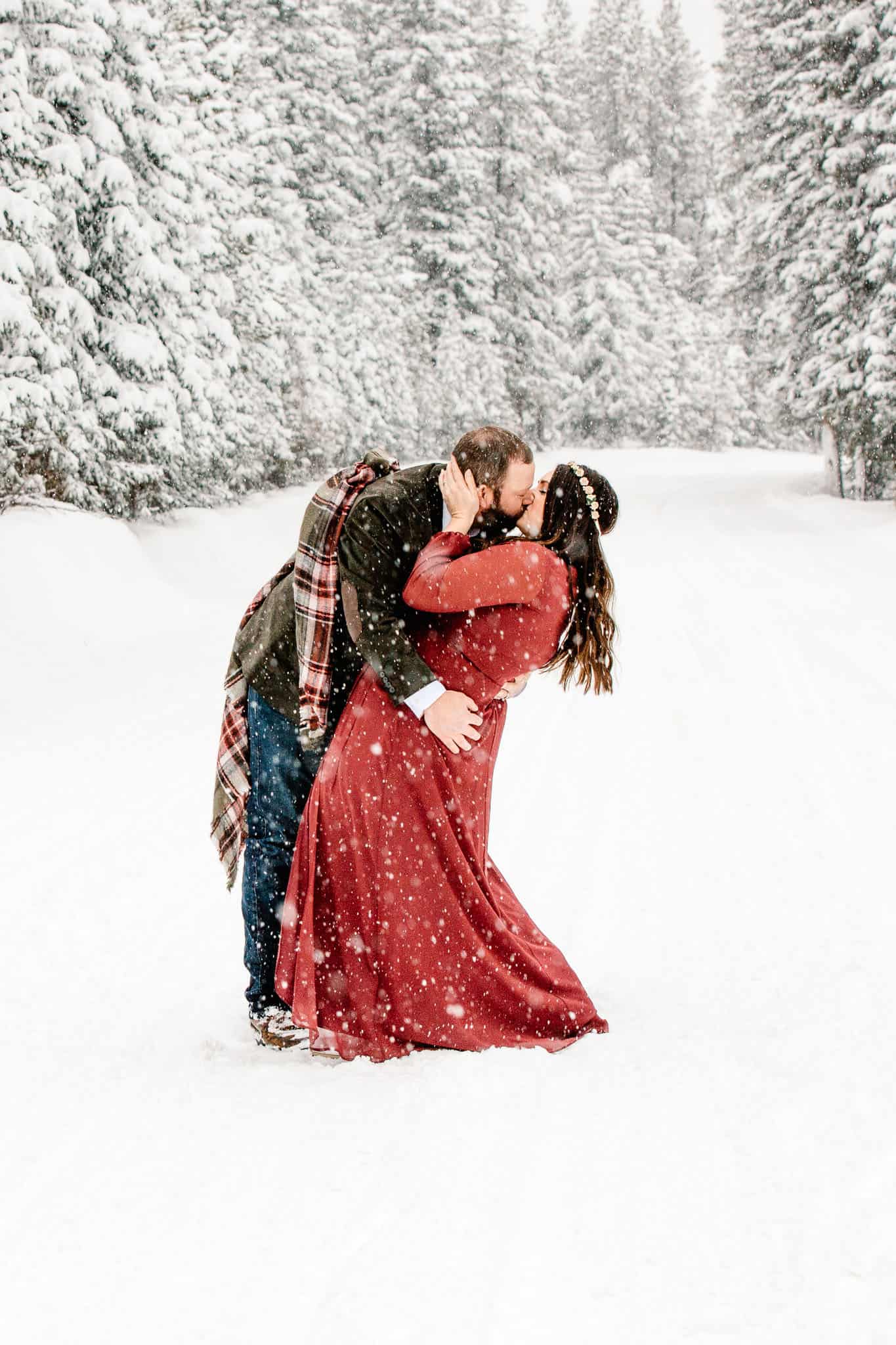 couple dancing in the snow on wedding day
