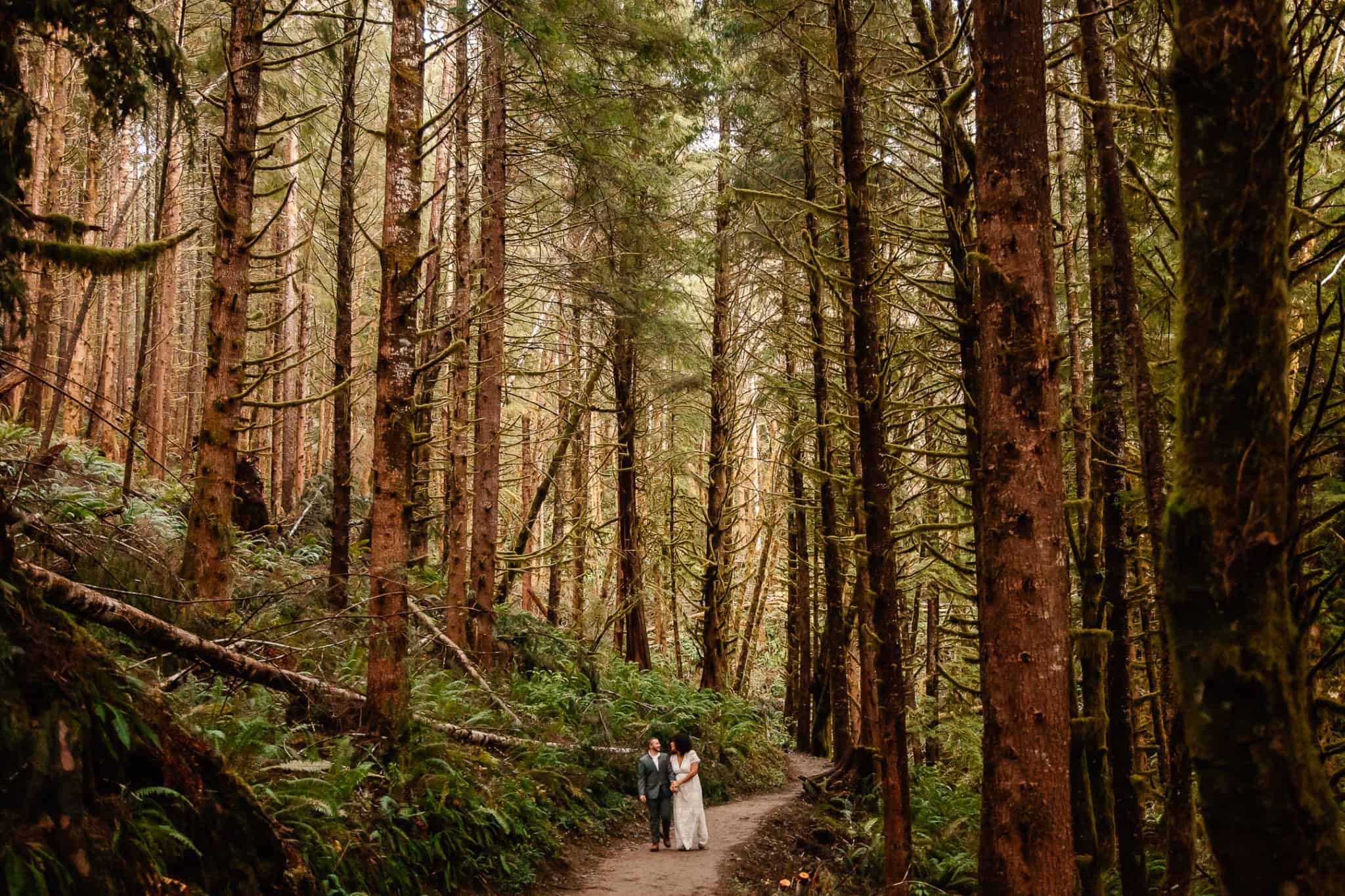 couple standing in the middle of trees enjoying one of the best places to elope in Oregon