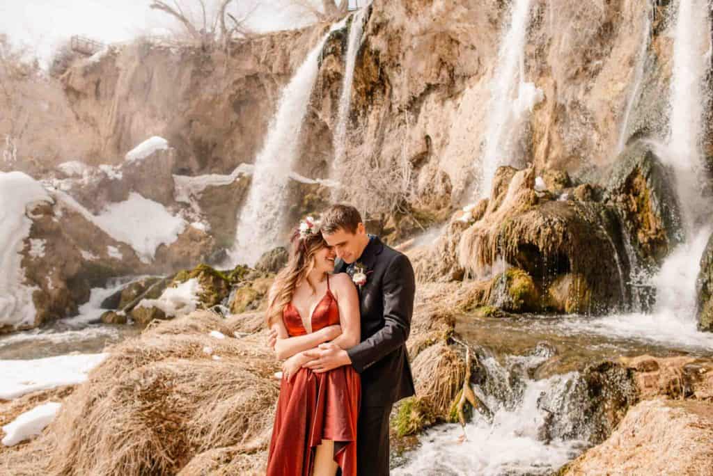 couples connection experience couple hugging in front of a waterfall
