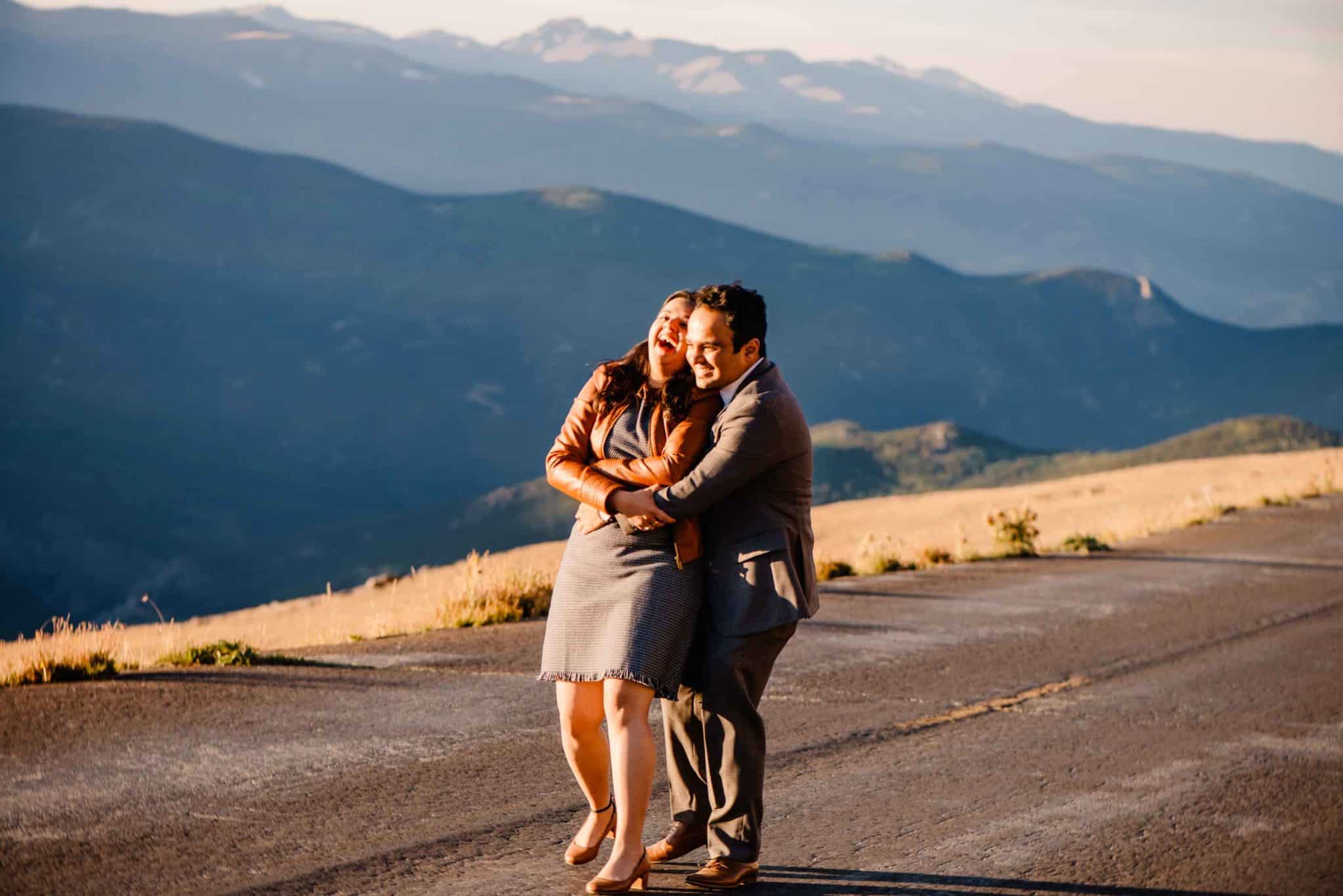 couple hugging in front of a mountain view during a couples connection experience