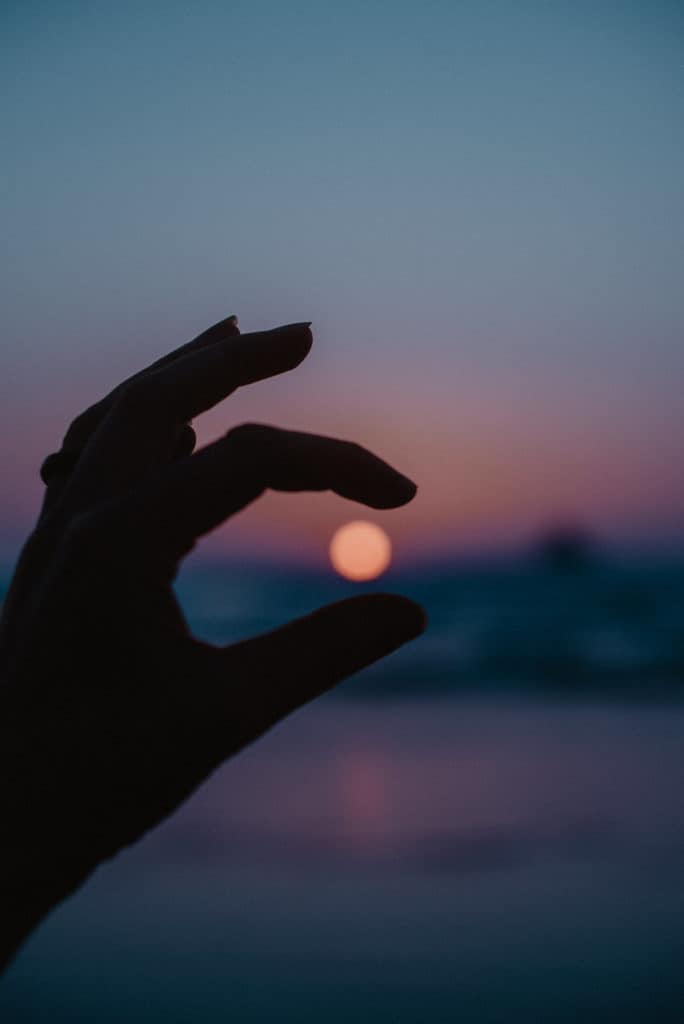 hand holding colorful sunset