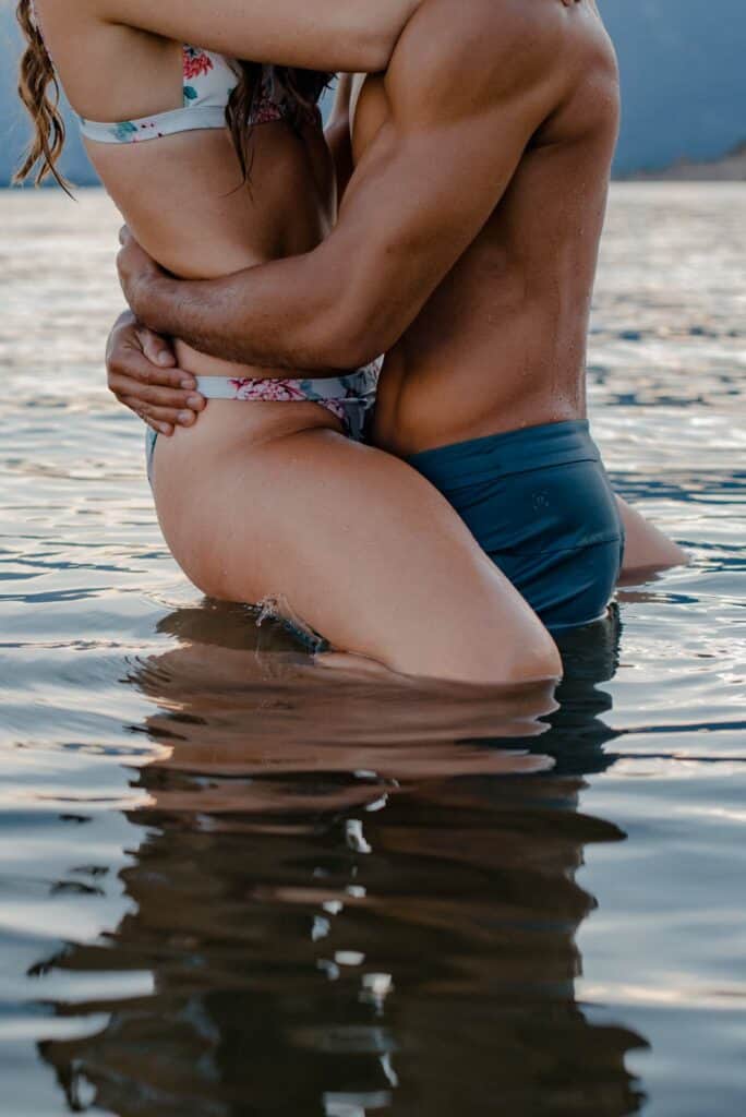 couple passionately hugging in water