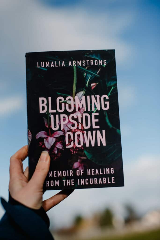 book on self improvement being held up in the sky Blooming Upside Down