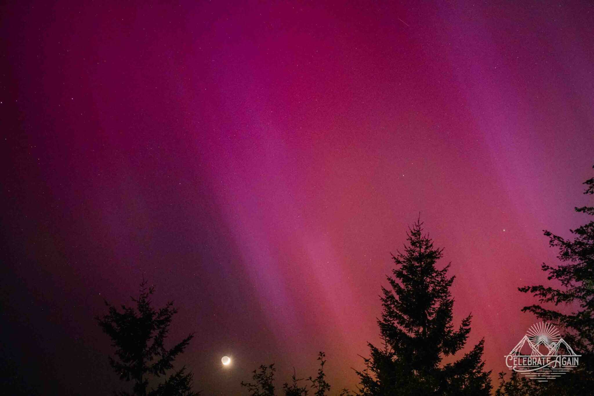 northern lights in Oregon May 2024 aurora borealis in Oregon by Lumalia Armstrong with deep magentas and the moon glowing slightly in the center