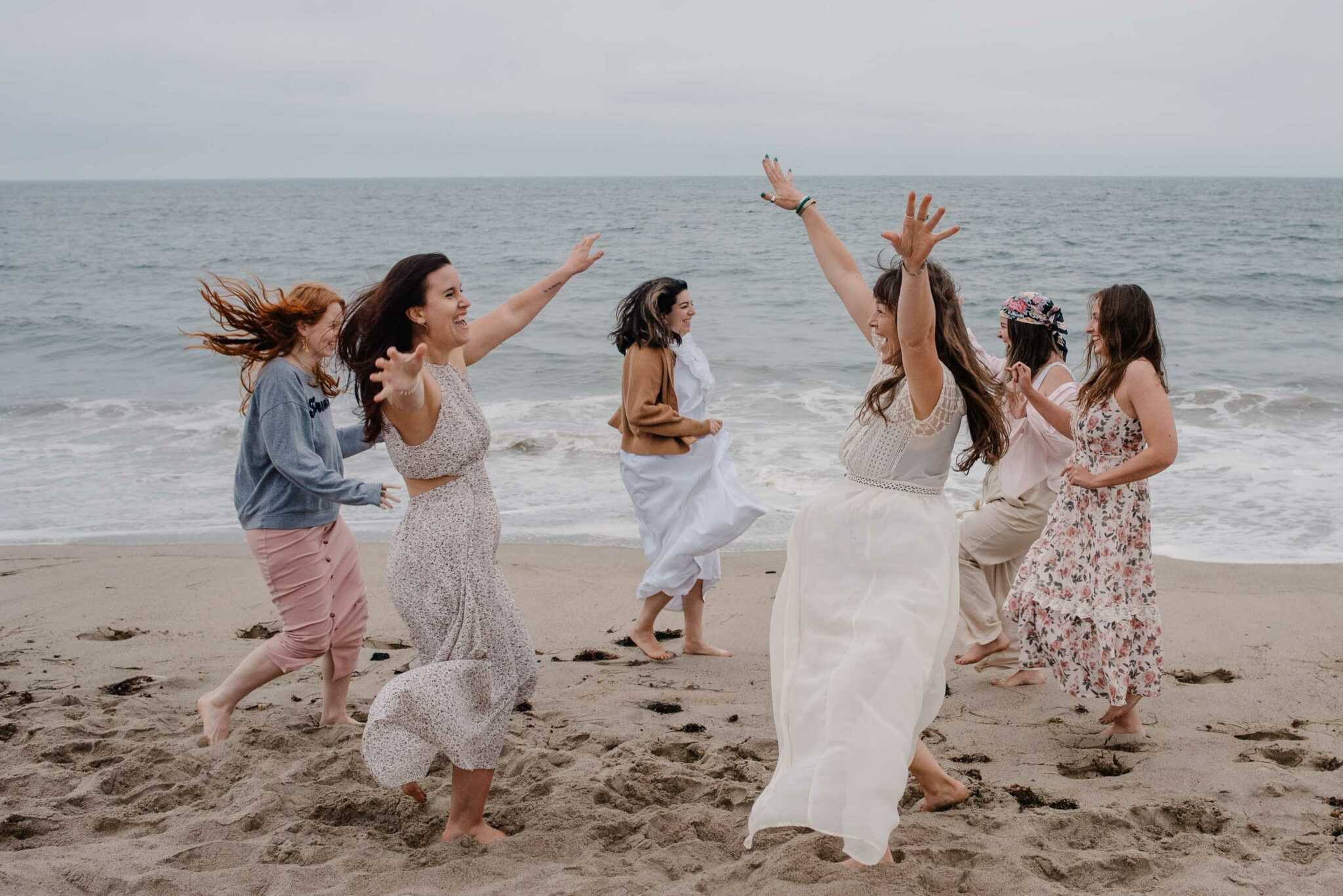 women gathering at a womens retreat on the coast of Oregon running to each other