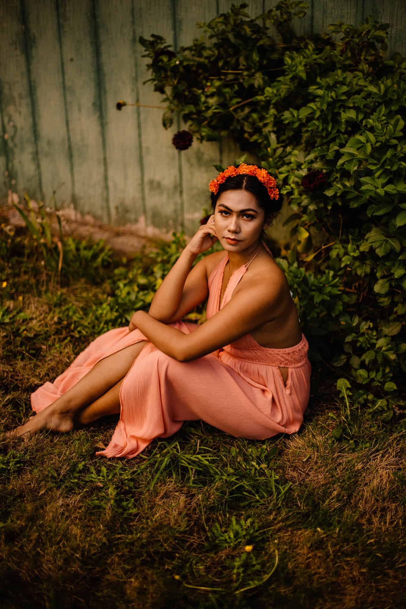 female in a dress sitting near a bush at a womens retreat in Oregon