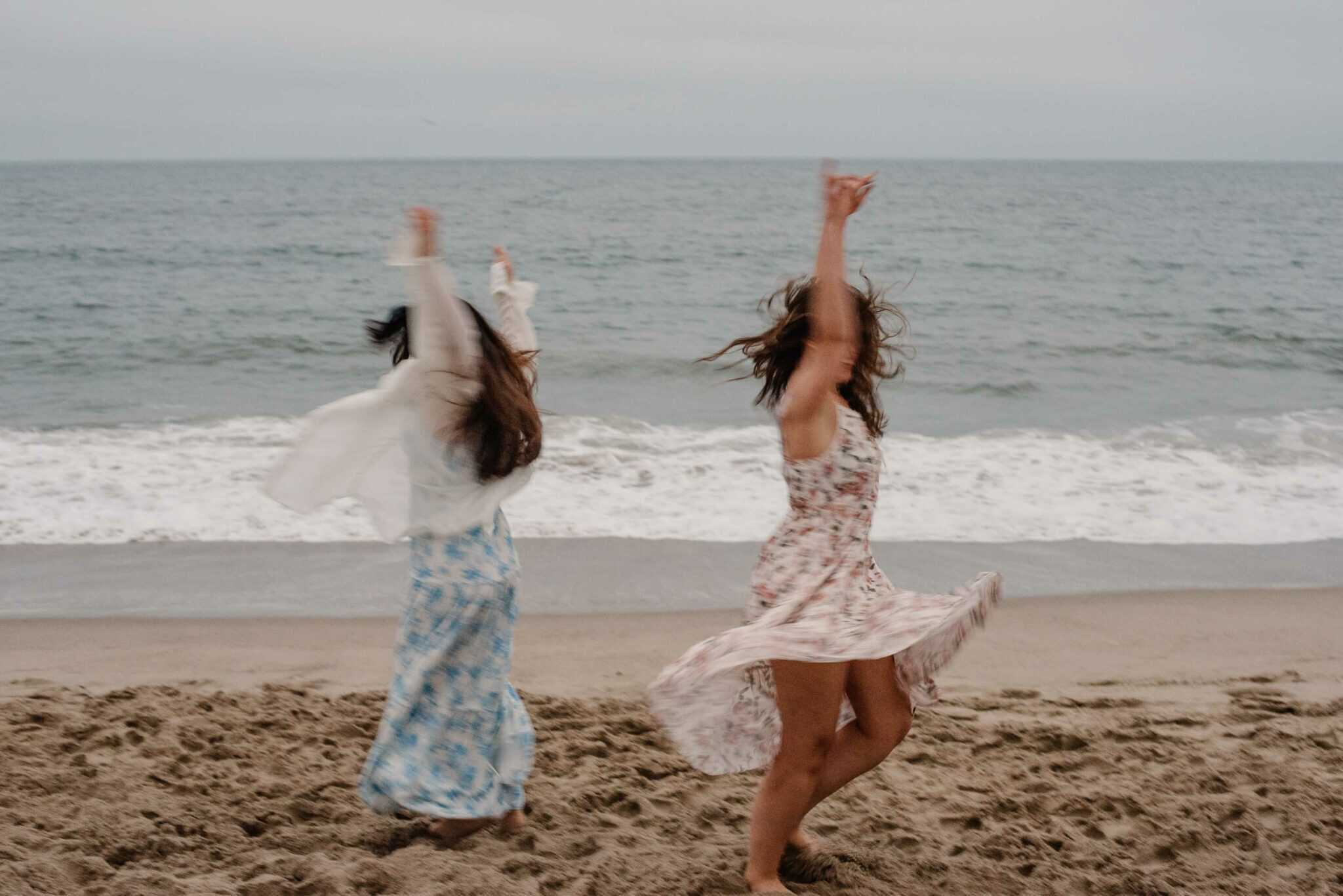 women dancing at a beach