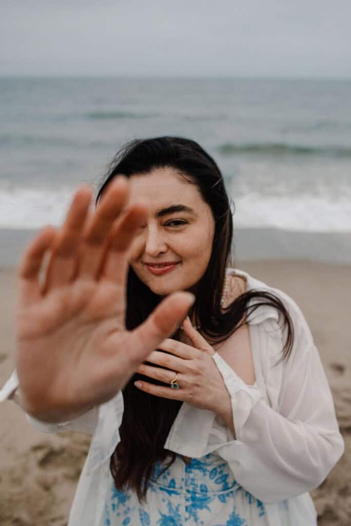 woman holding out her hands during a group womens boudoir photography experience