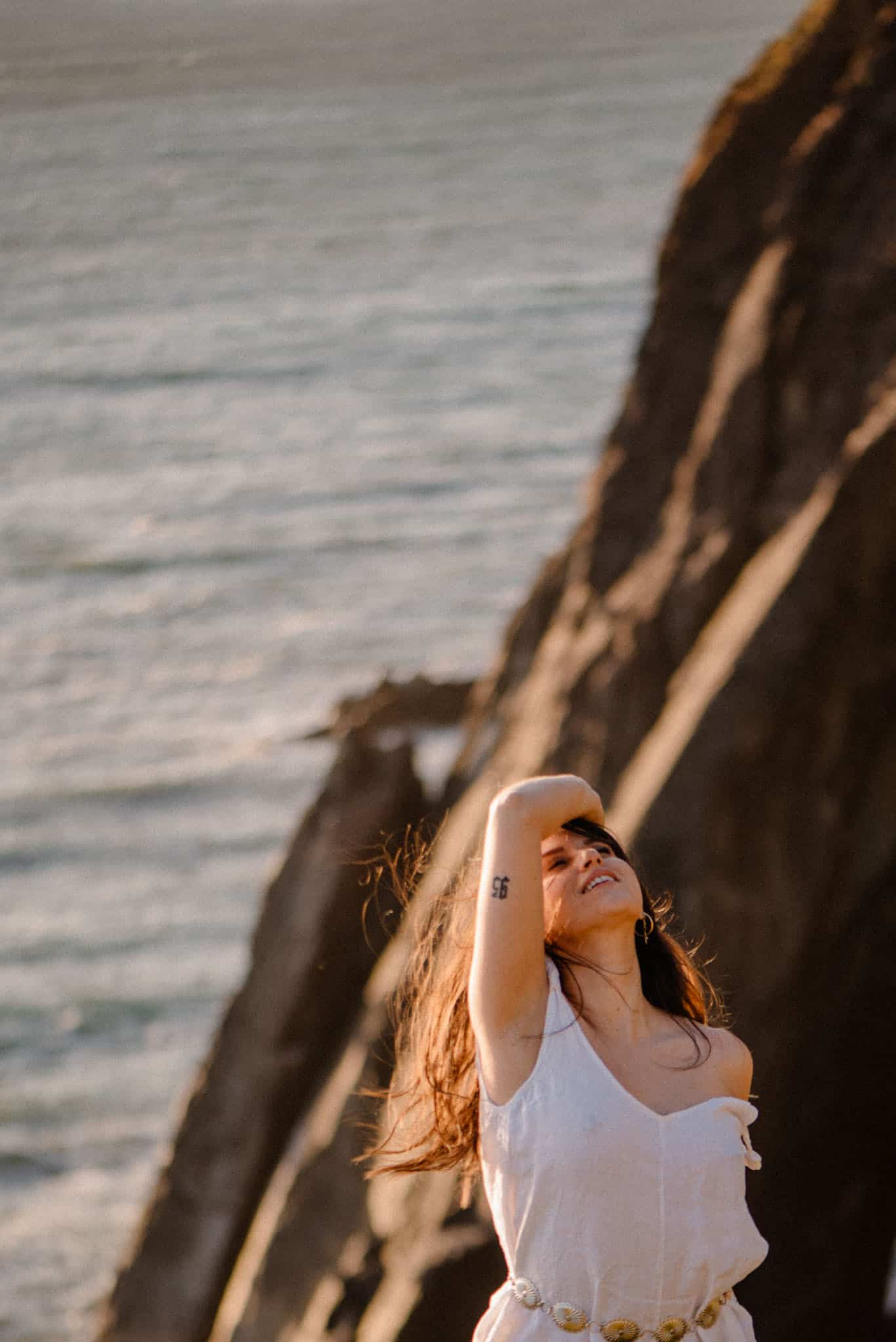 female on oregon coast with part of her shoulder strap coming down for an Oregon Boudoir photography priced package