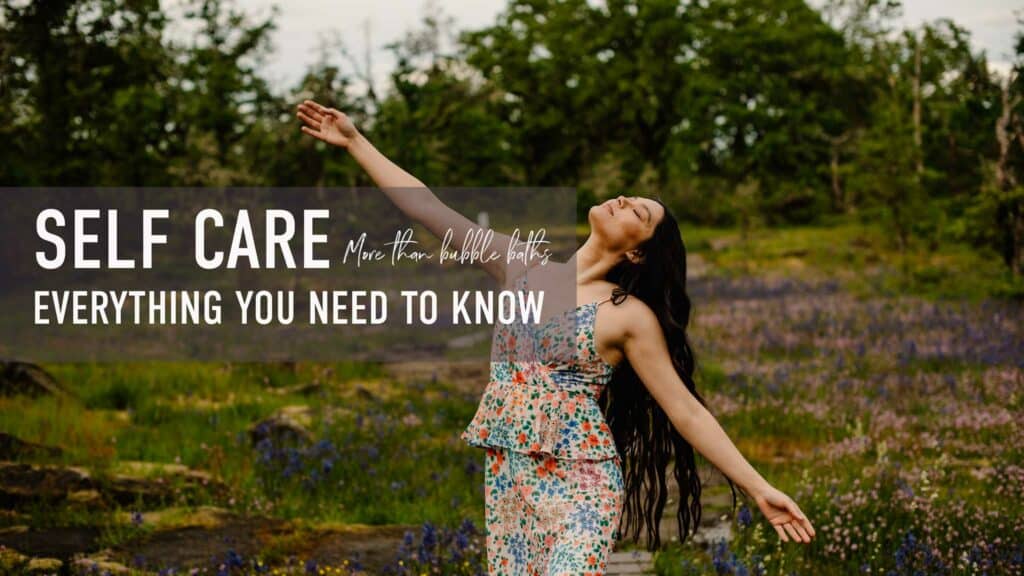 "self care more than bubble baths everything you need to know" a woman with arms stretched out wide near a wild flower field