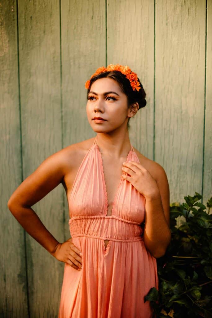 latina woman in dress and headdress embodying the siren archetype