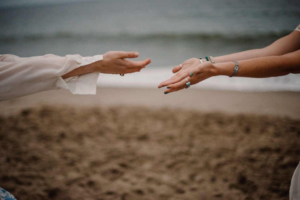 women's hands doing somatic partner work