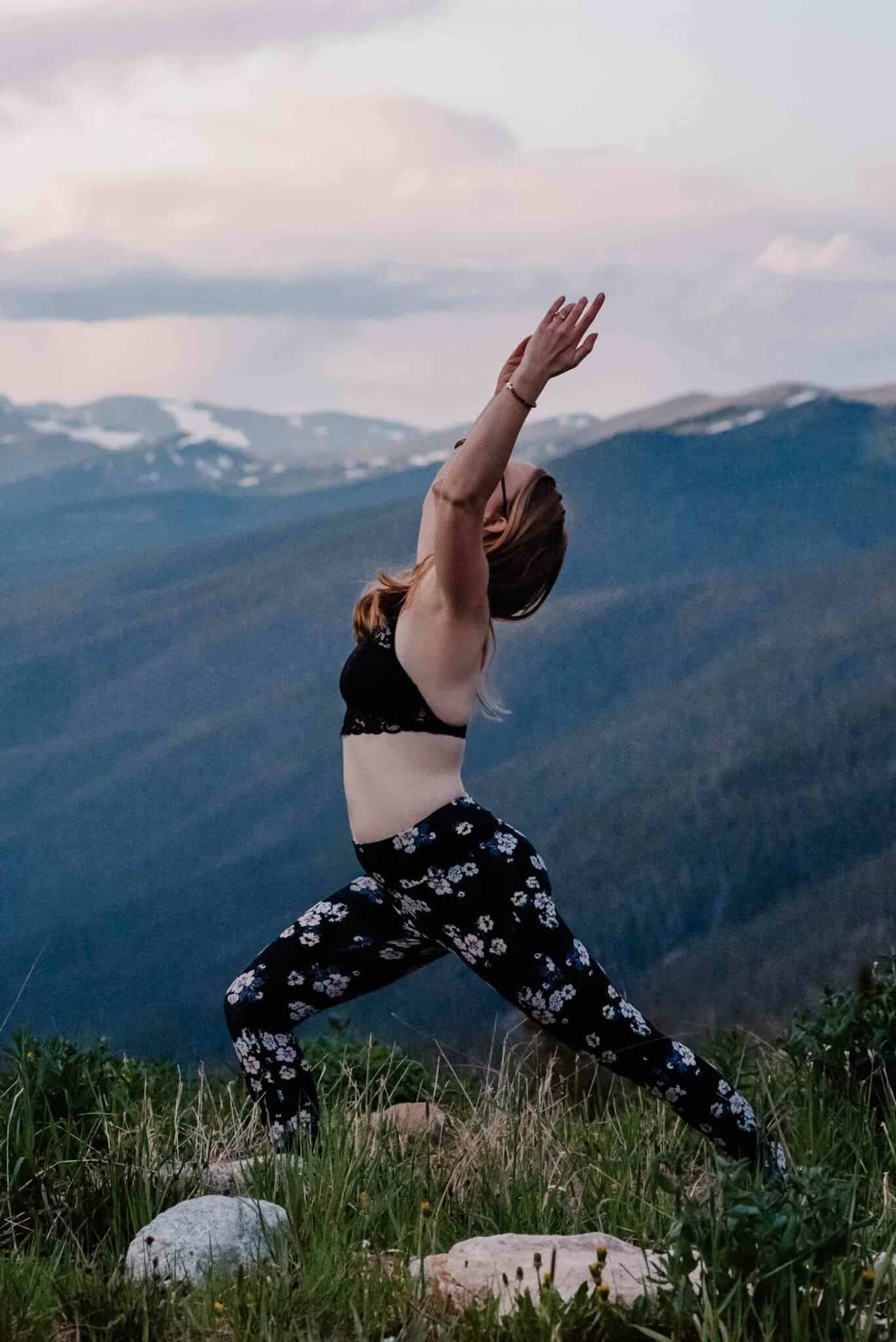 woman doing yoga on a mountain top