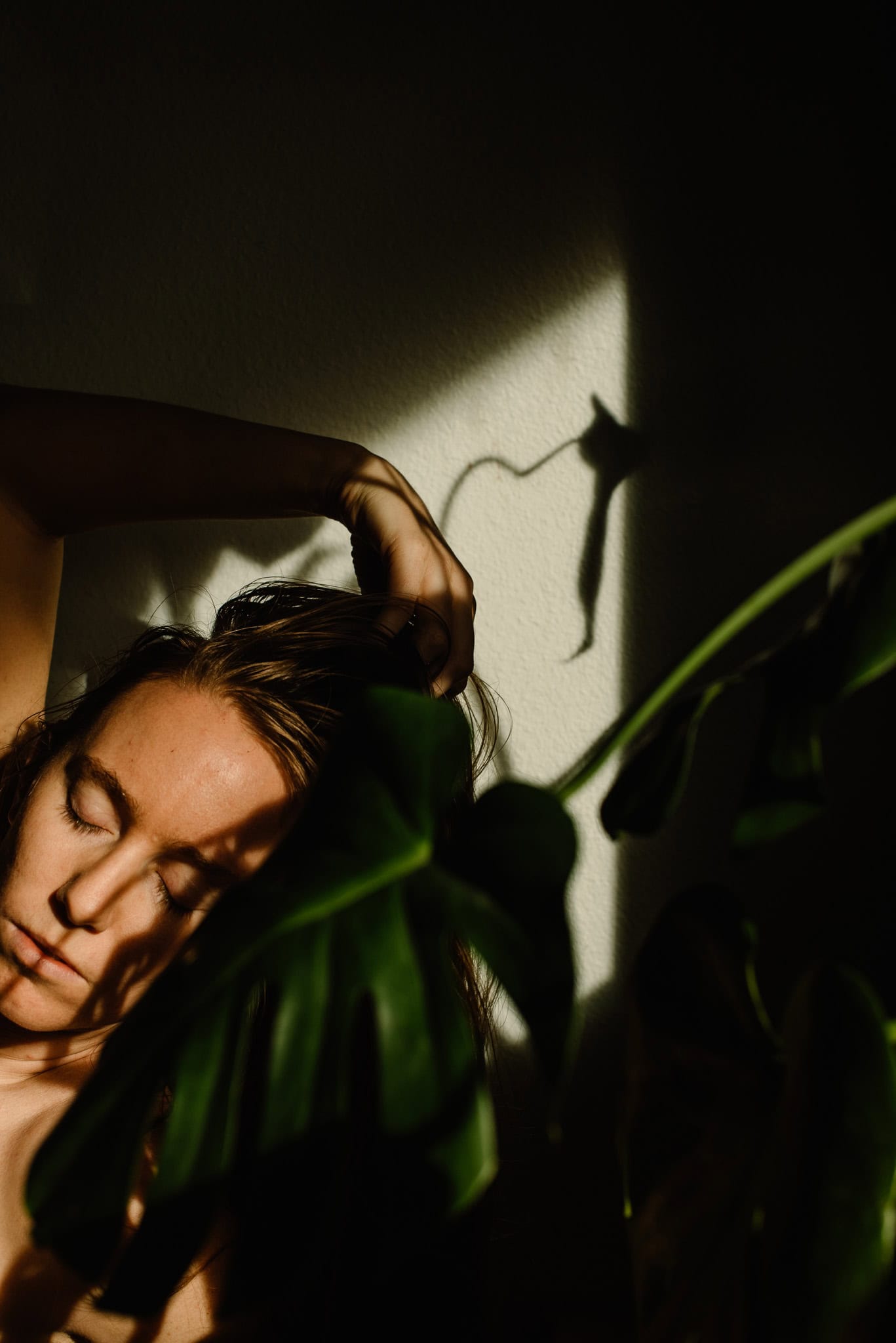 woman near a plant in shadows feeling feels after learning how to feel your feelings