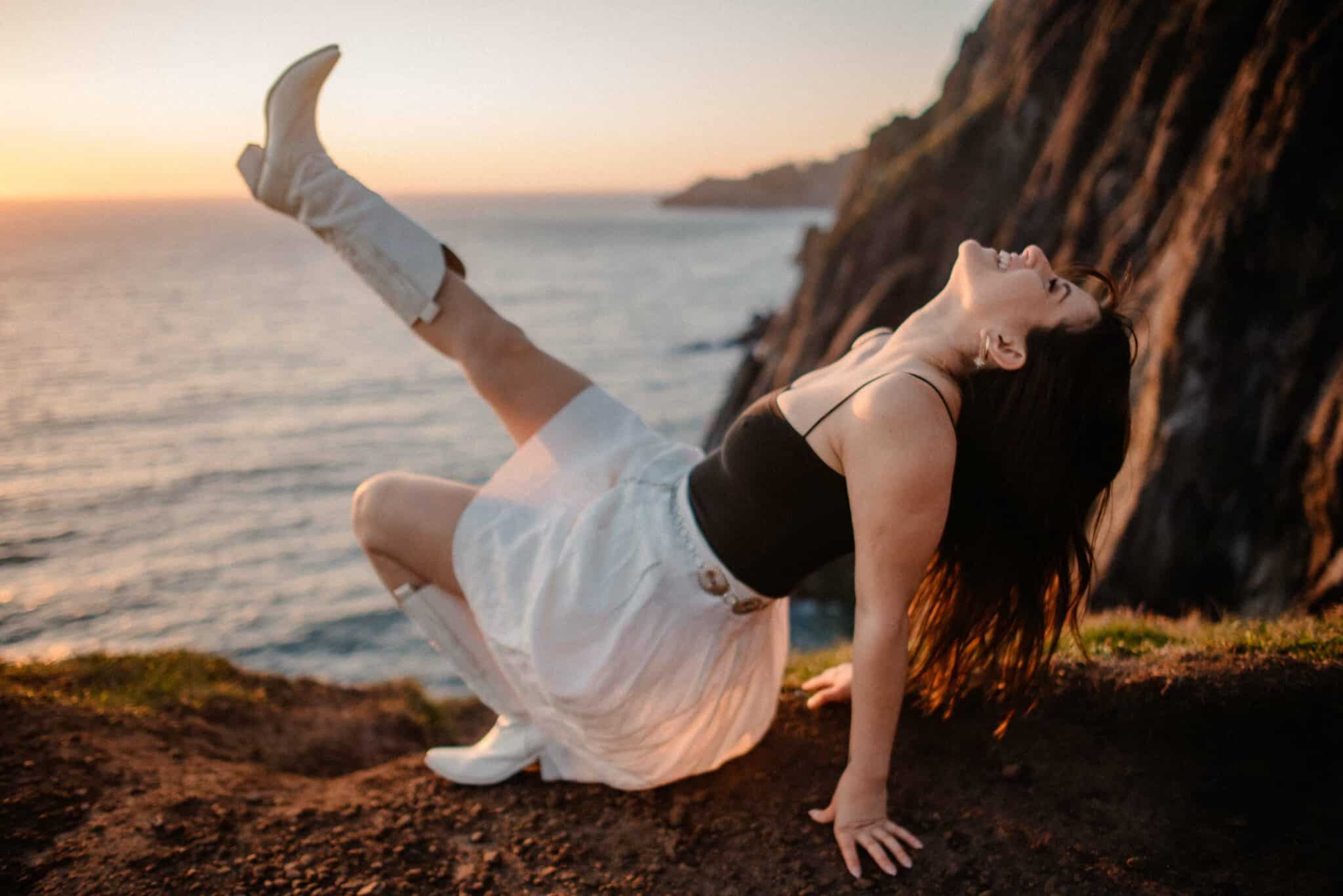 woman with ocean in the background during boudoir photo shoot