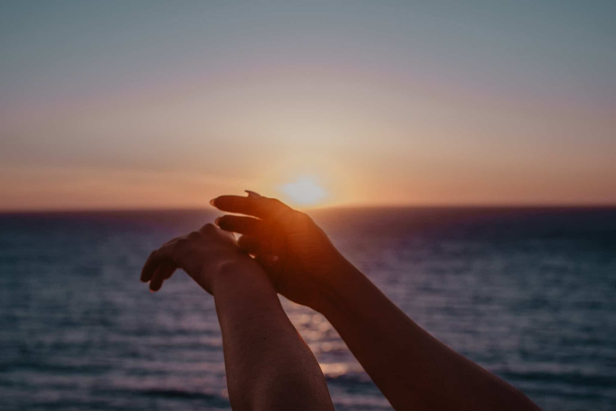 woman's hand during sunset at boudoir photography session